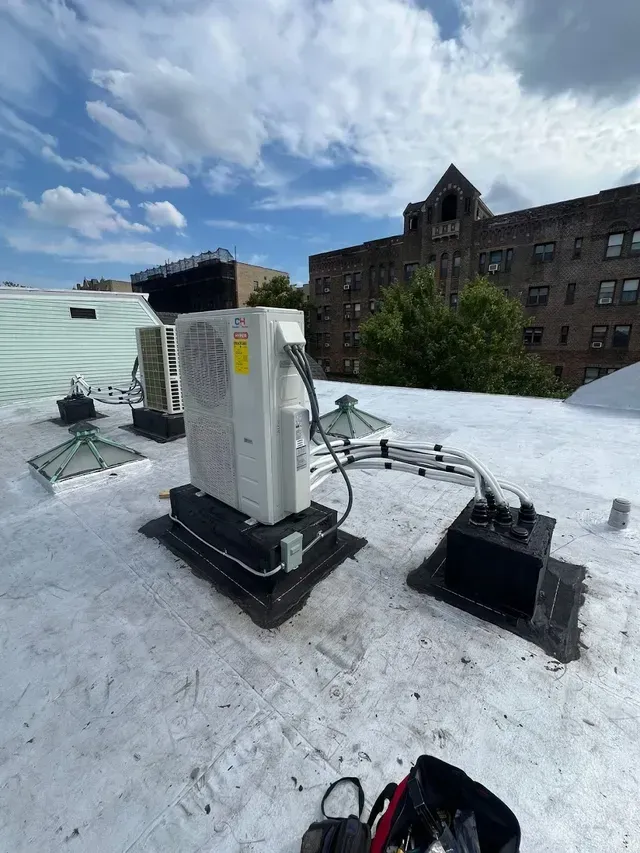 Living room with wood trim, rug, sofa, desk, and view into a stairwell.