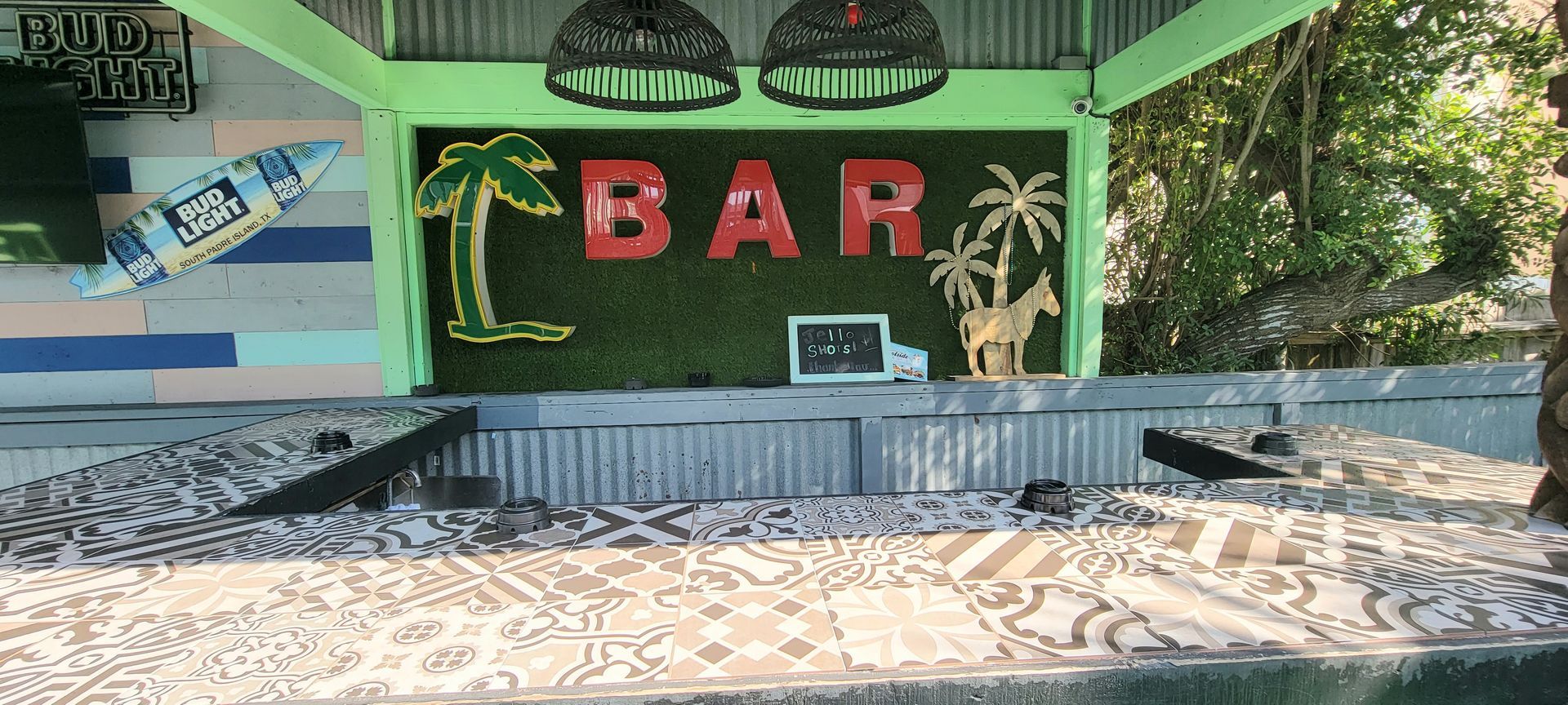 a bar with palm trees and a surfboard on the wall .