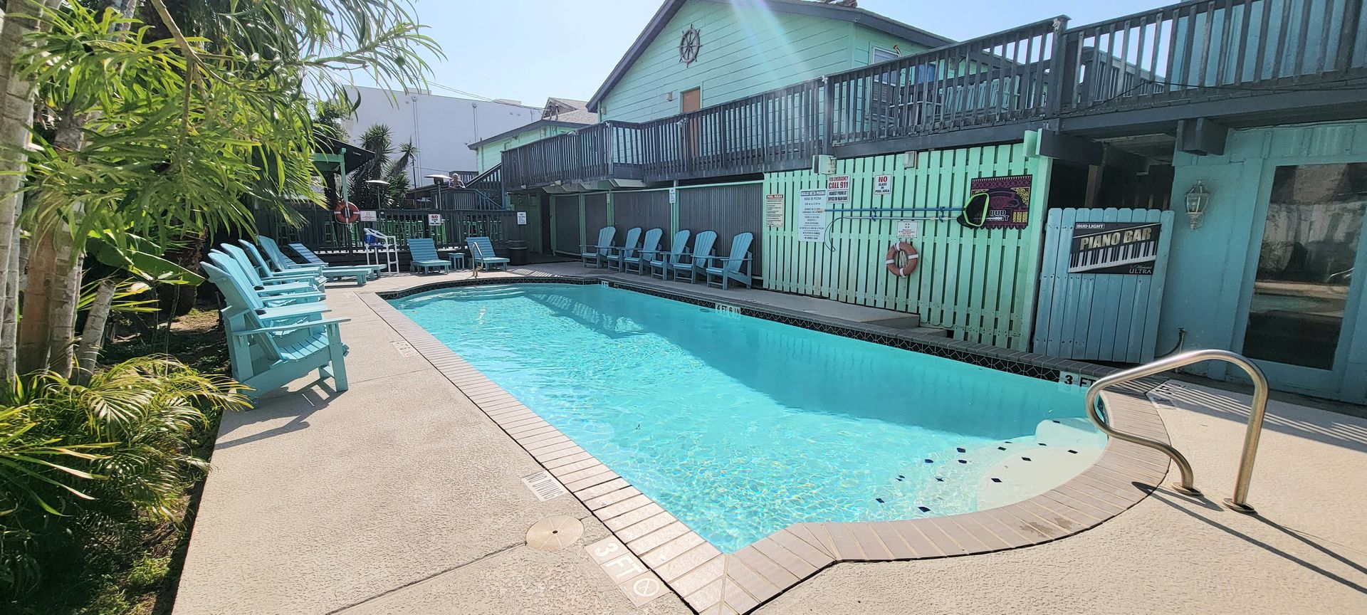 there is a large swimming pool in front of a house .