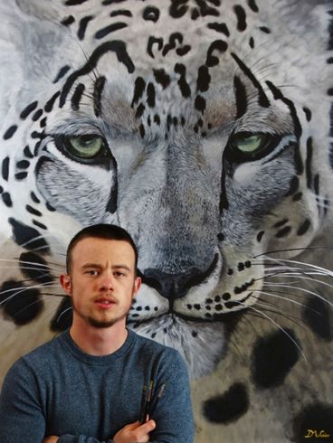 A man standing in front of a painting of a leopard