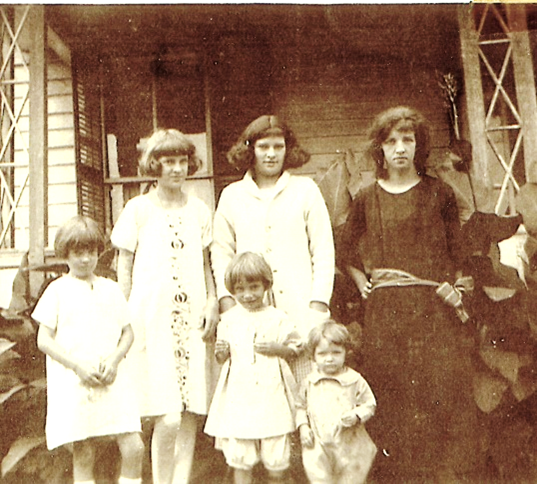 A black and white photo of a family posing for a picture