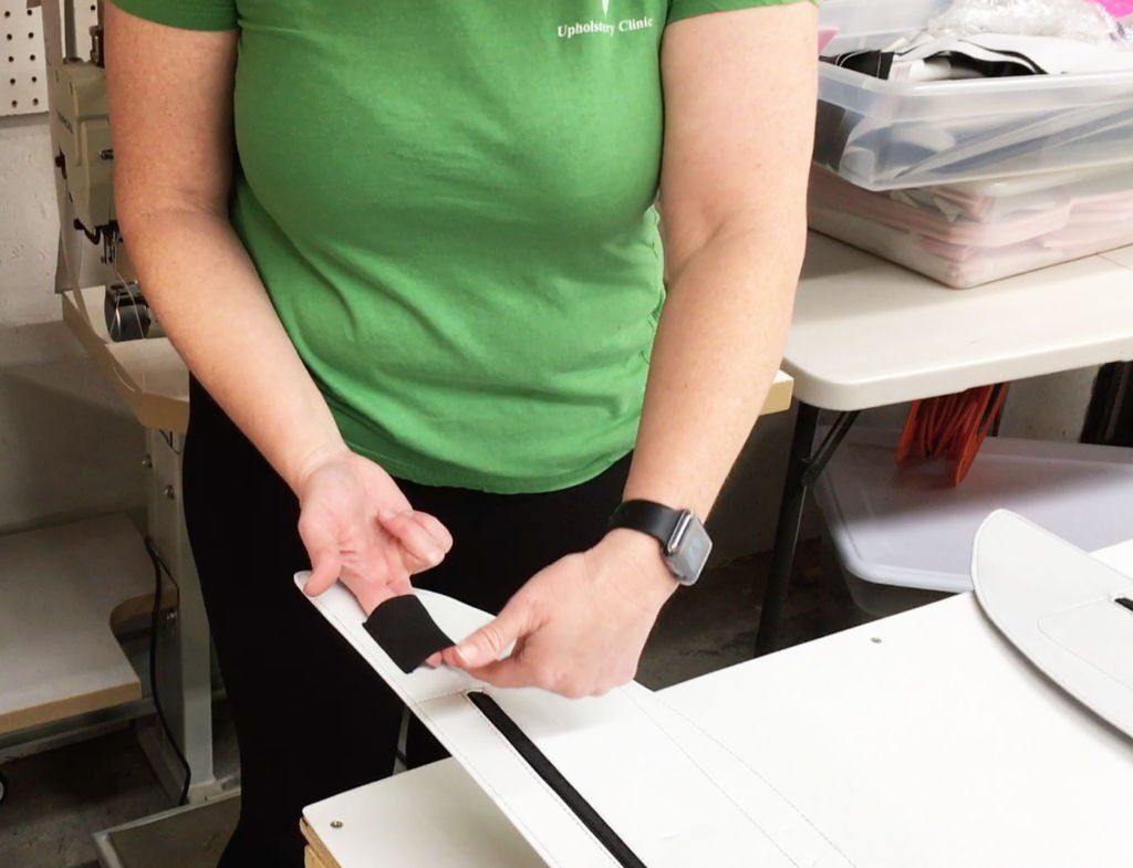 Dr. Rachel working on an upholstery section for a plane