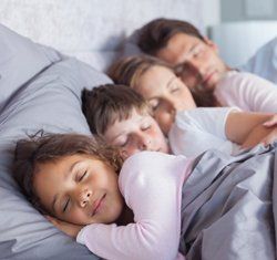 Family Sleeping in Bed