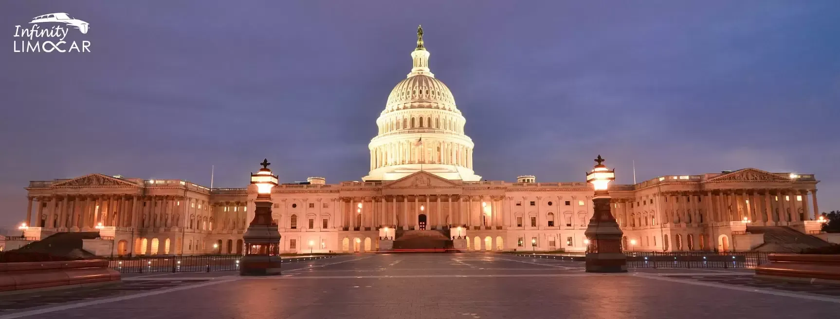 The U.S. Capitol Building illuminated at dusk against a dusky blue sky.