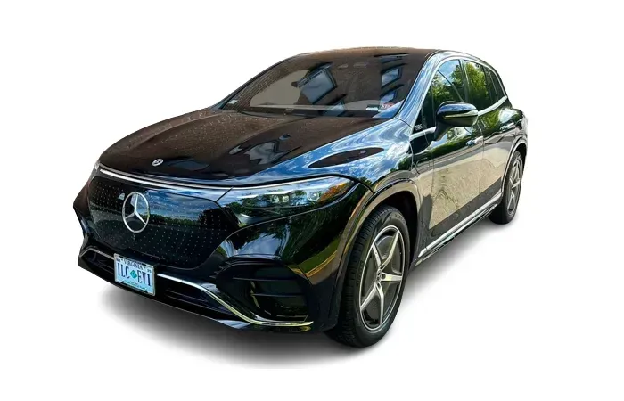 Black Mercedes-Benz EQS SUV, angled view, on a white background. Front view showing headlights and grill.