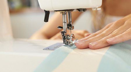 a lady using a sewing machine