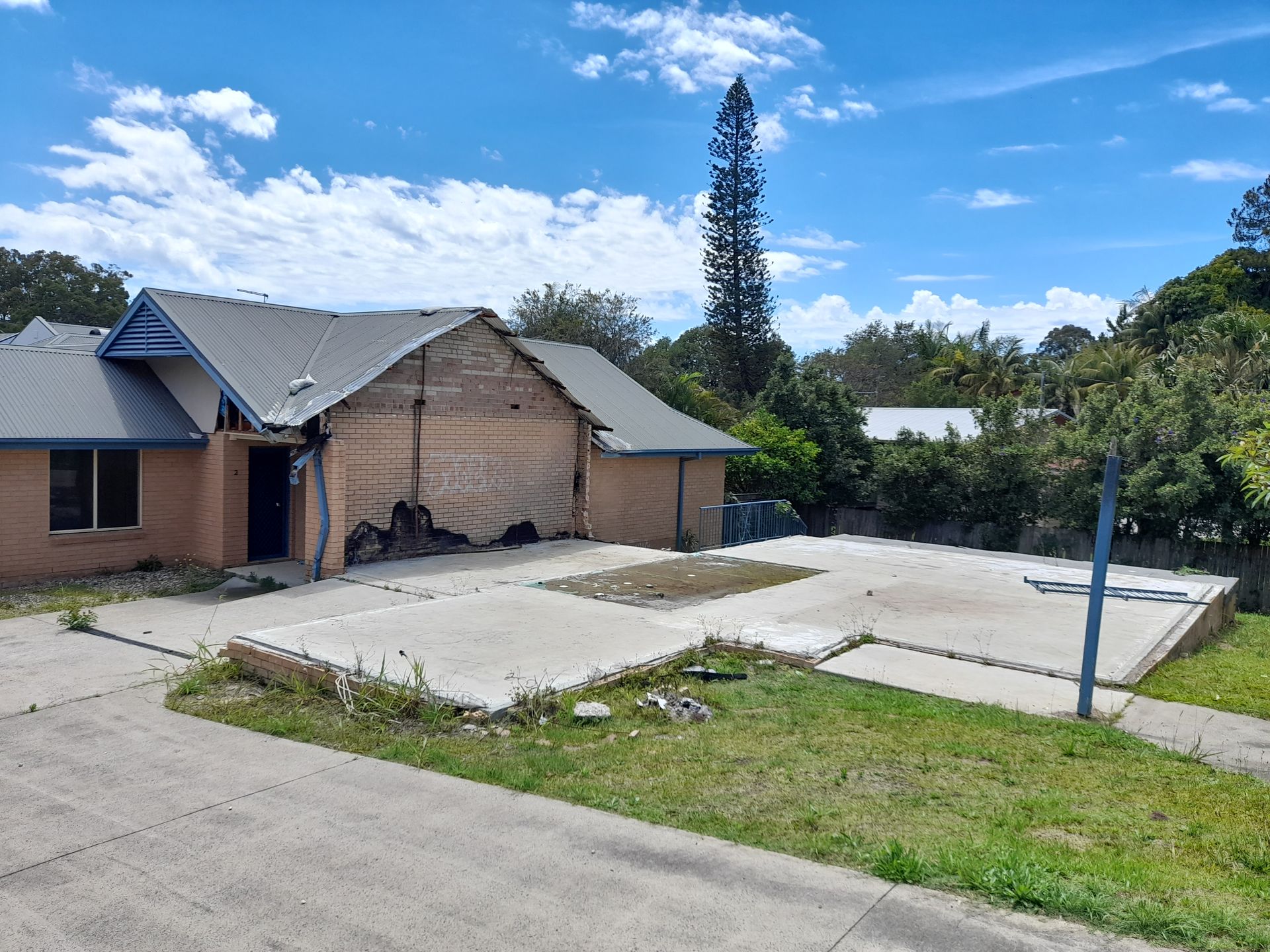A House With a Concrete Driveway in Front of It — BK Build Group in Coffs Harbour, NSW