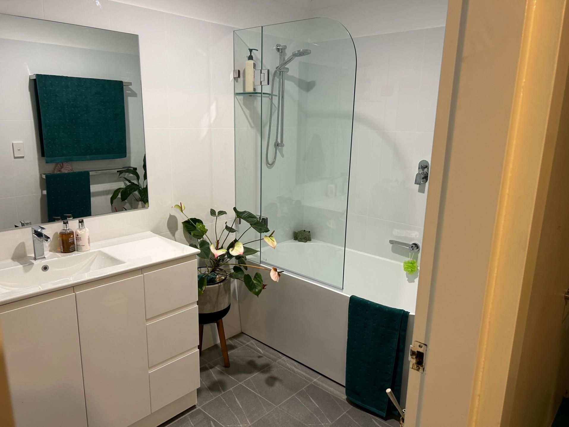 A Bathroom With a Sink , Tub , Shower and Mirror — BK Build Group in Nambucca Heads, NSW
