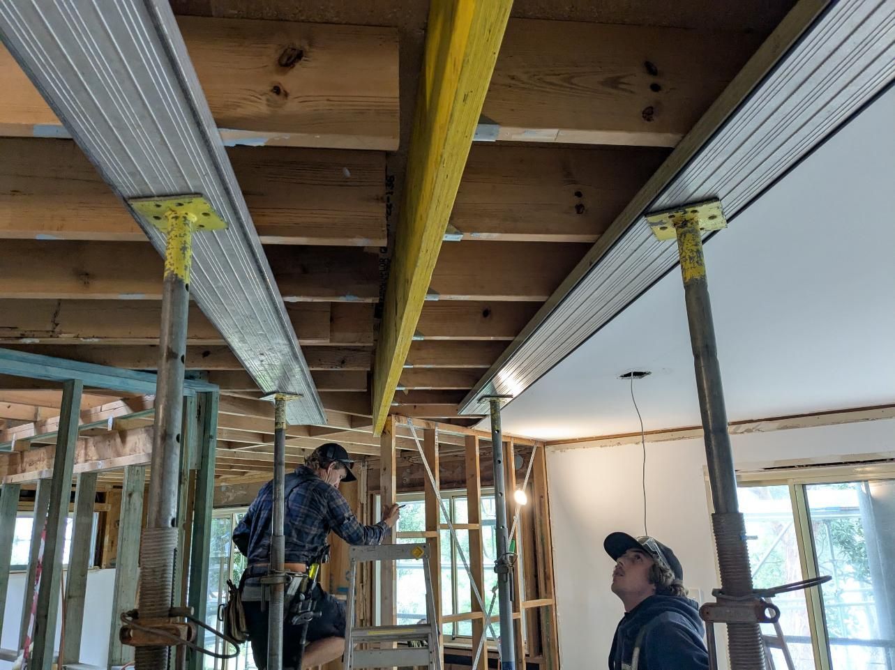 Two Men Are Working on the Ceiling of a Building — BK Build Group in Bellingen, NSW