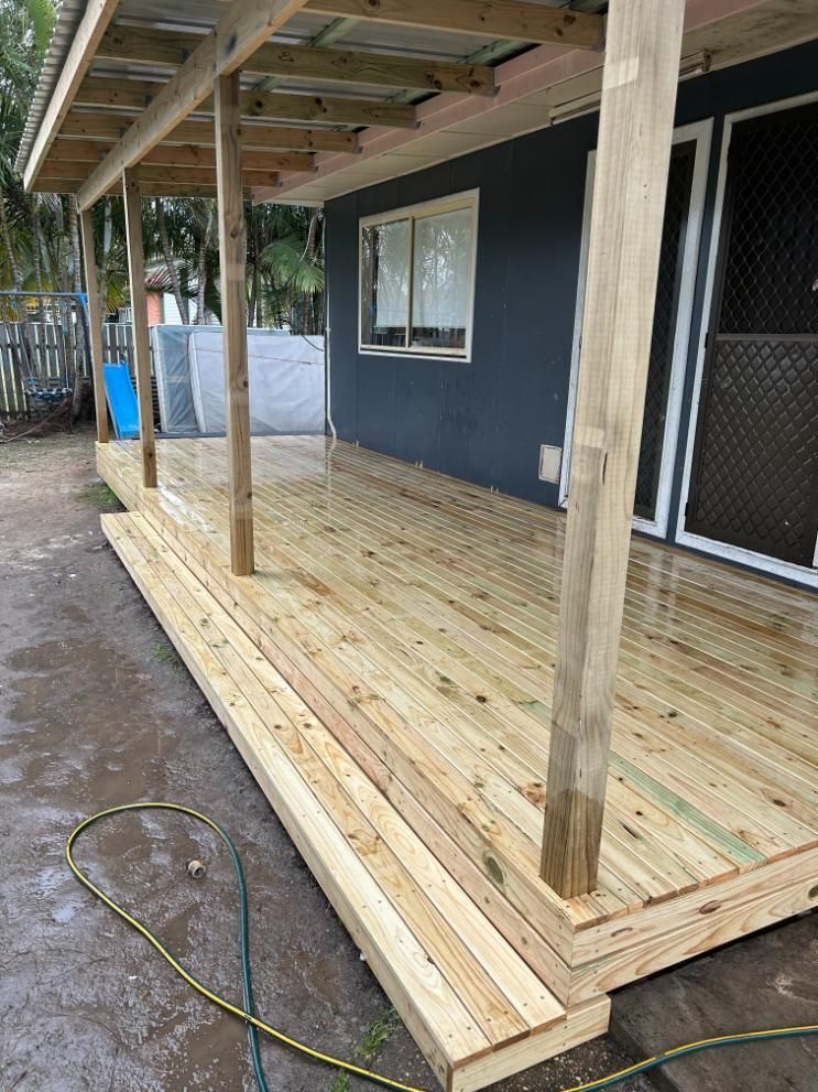 A Wooden Deck is Being Built on the Side of a House — BK Build Group in Bellingen, NSW