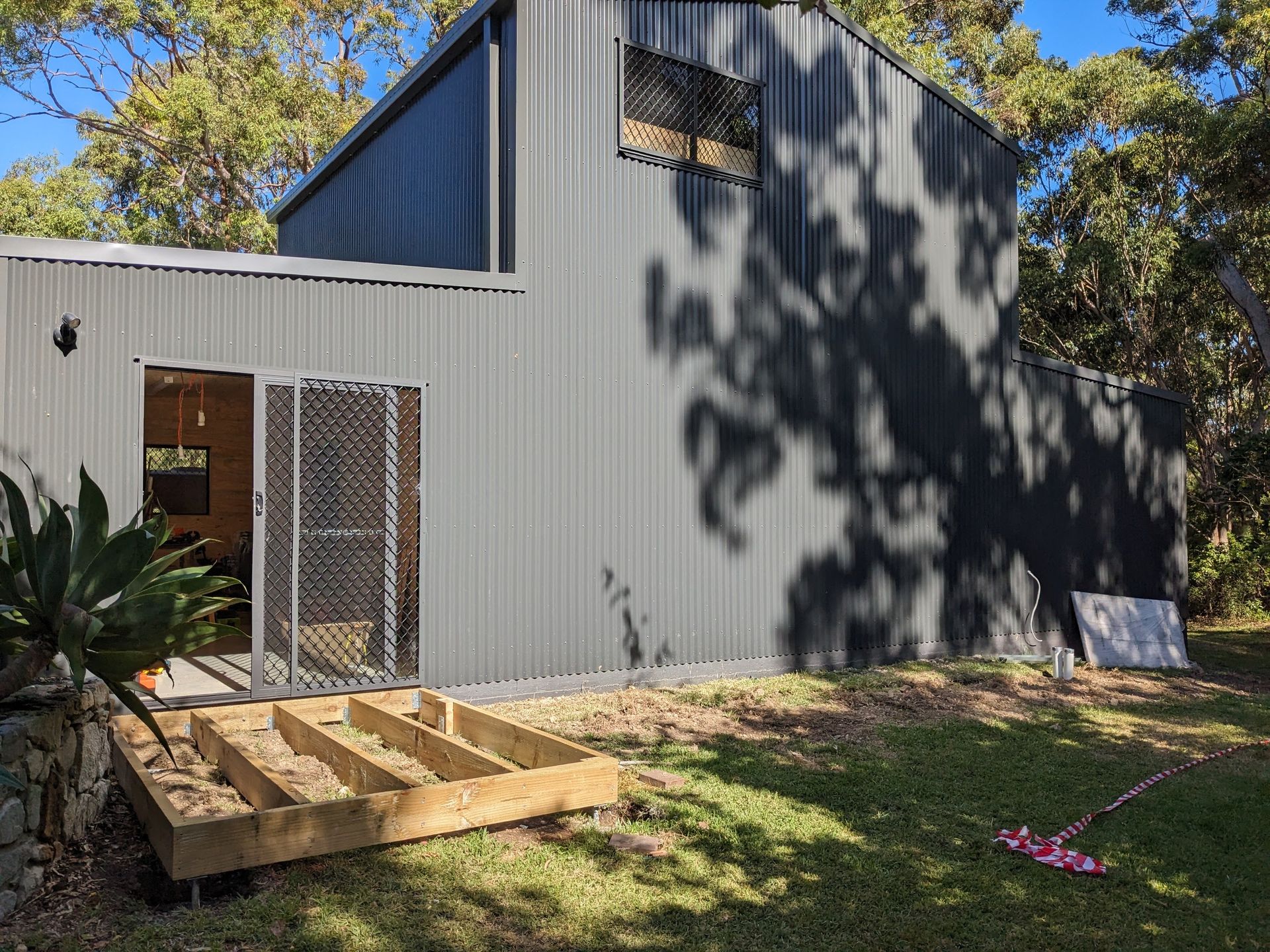 A Black Building With Stairs Leading Up to It — BK Build Group in Coffs Harbour, NSW