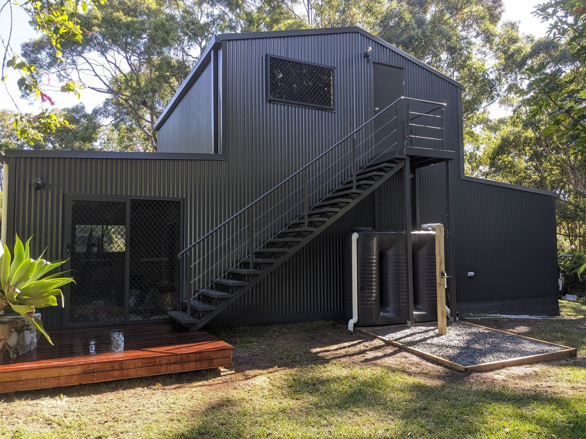 A Black Building With Stairs Leading Up to It — BK Build Group in Coffs Harbour, NSW