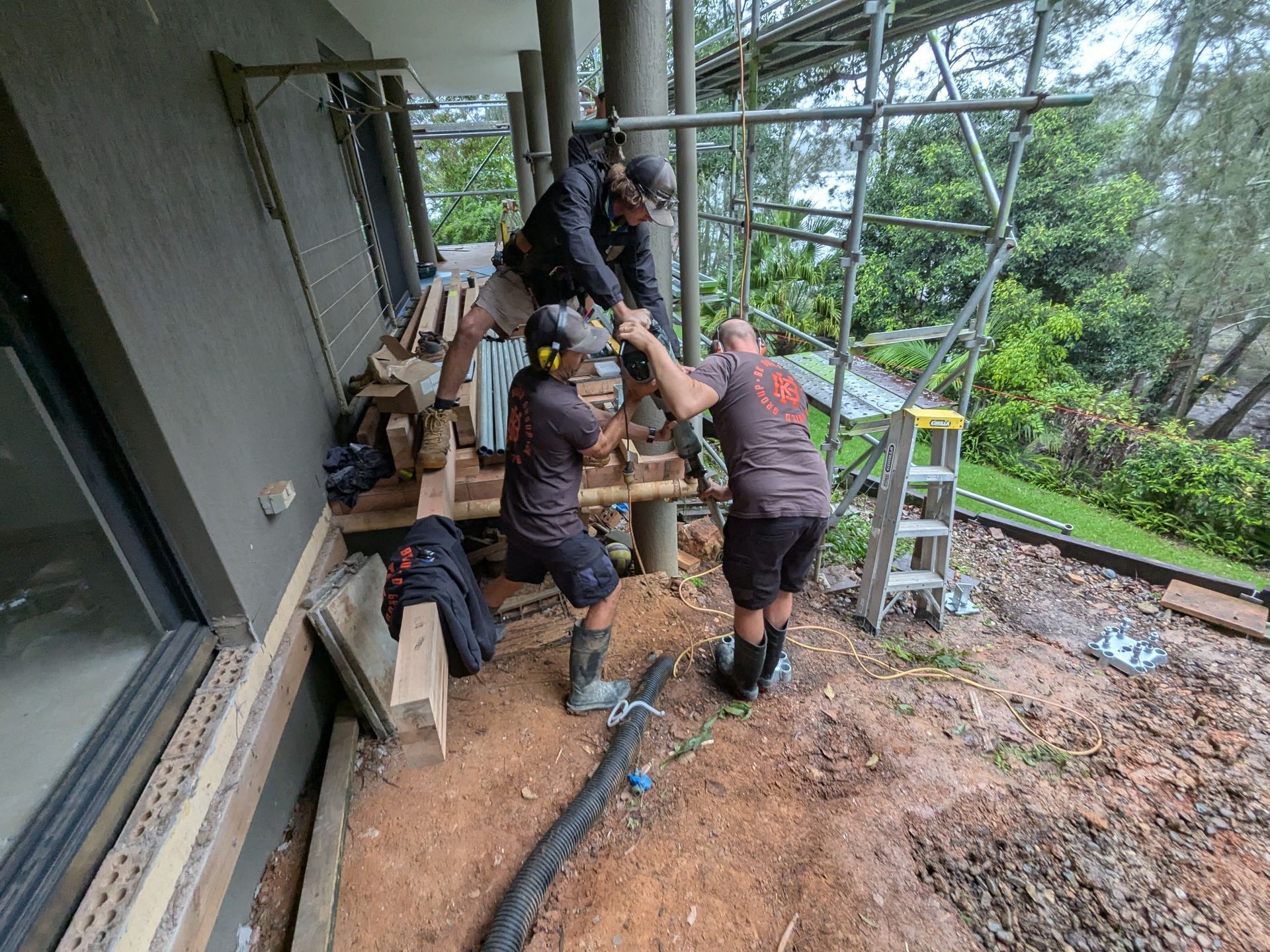 A Group of Men Are Working on a Porch — BK Build Group in Coffs Harbour, NSW