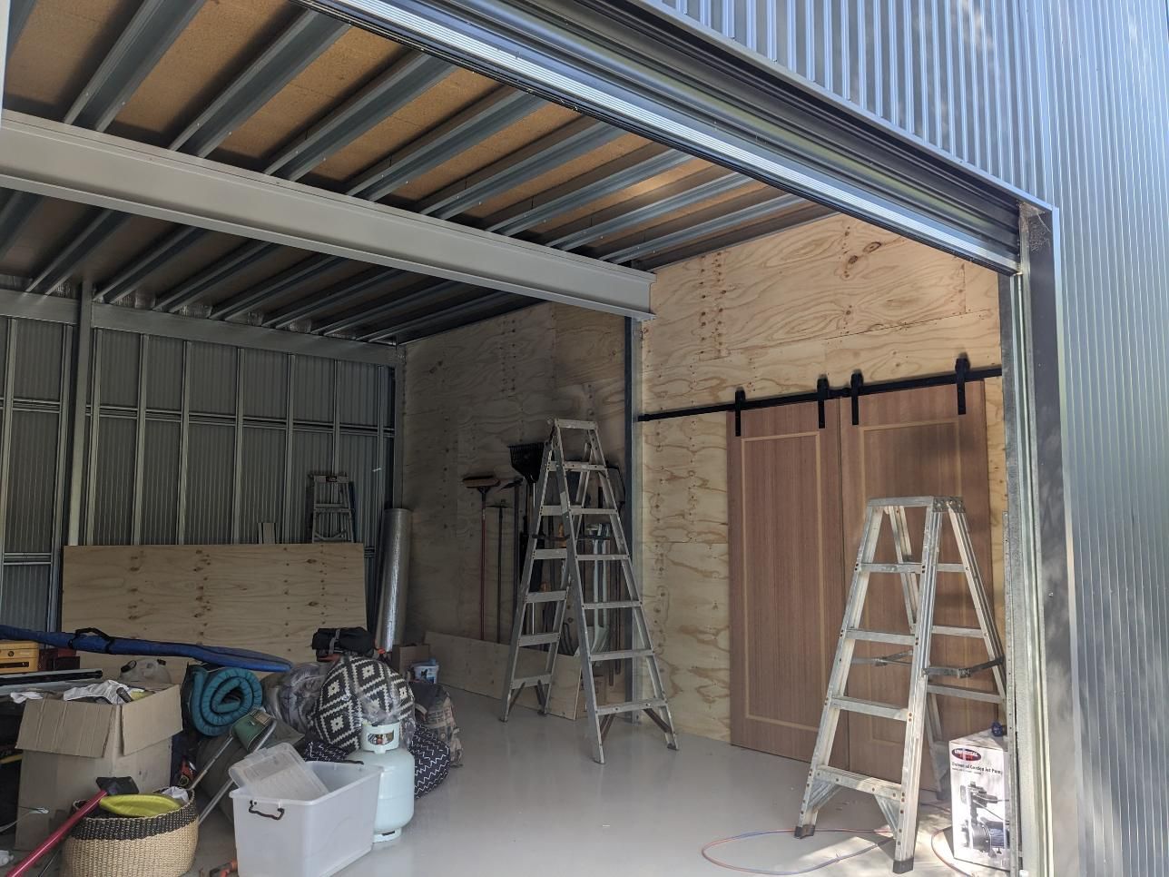 A Garage With a Ladder in the Middle of It — BK Build Group in Sawtell, NSW