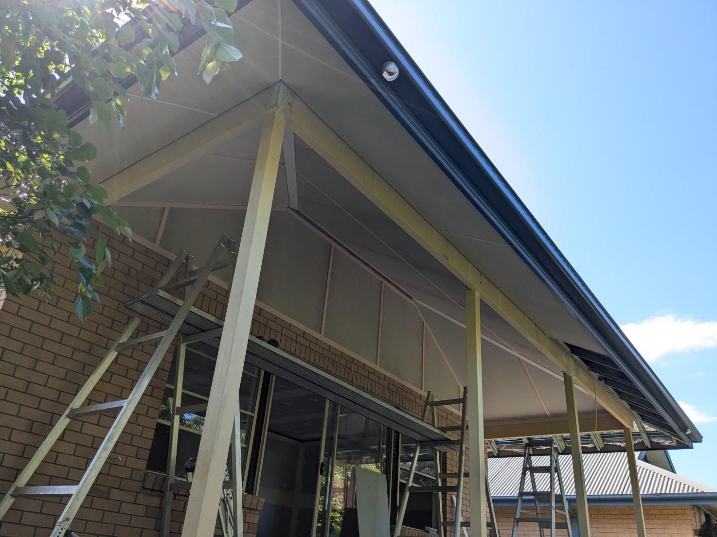 A Brick Building With a Roof That is Being Built — BK Build Group in Nambucca Heads, NSW