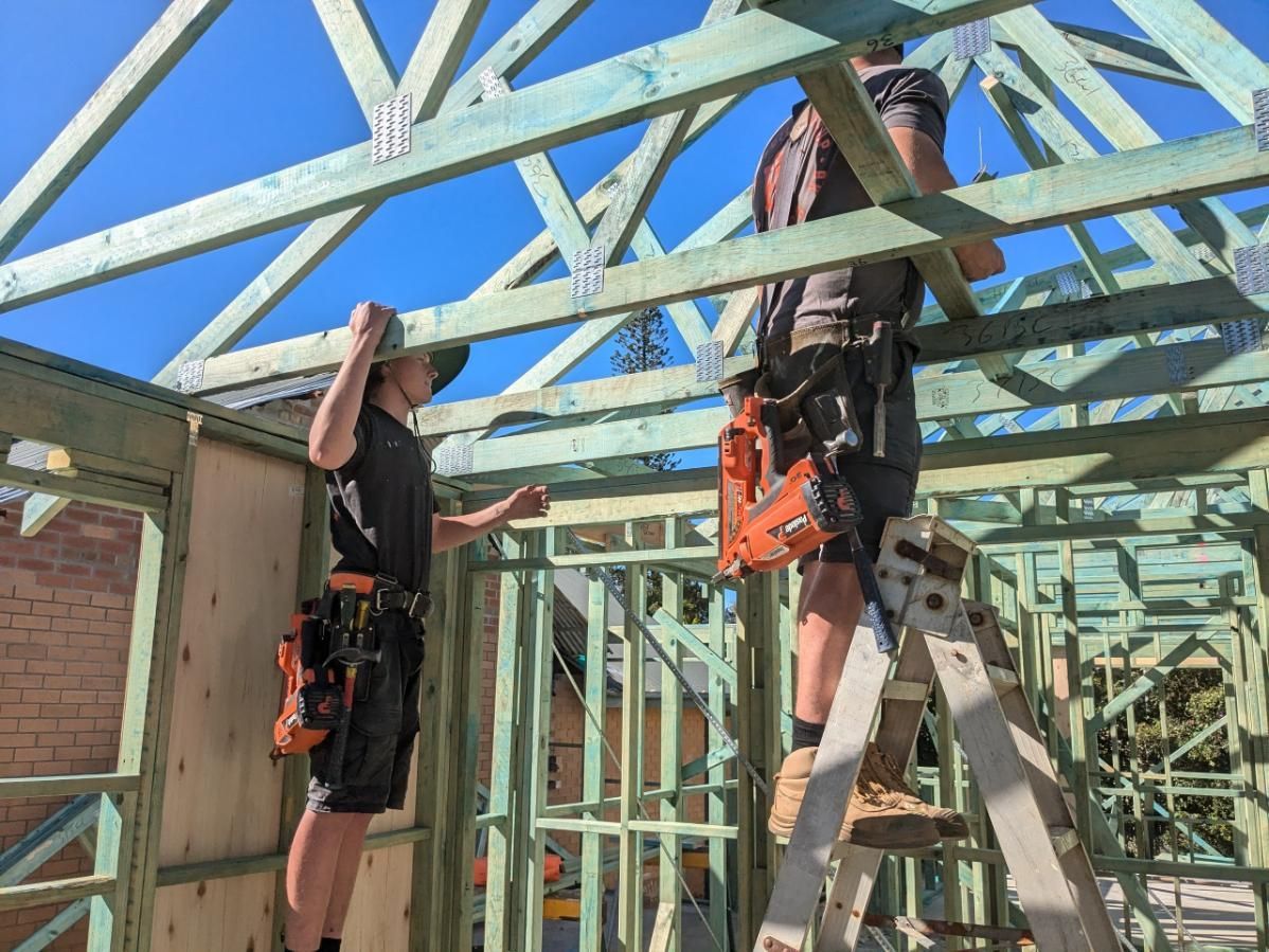 Two Men Are Working on the Roof of a Building — BK Build Group in Nambucca Heads, NSW