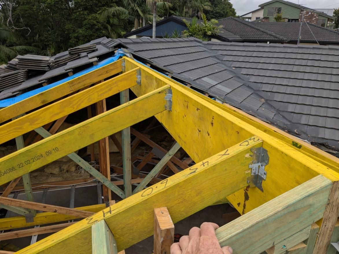 A Person is Working on the Roof of a House — BK Build Group in Woolgoolga, NSW