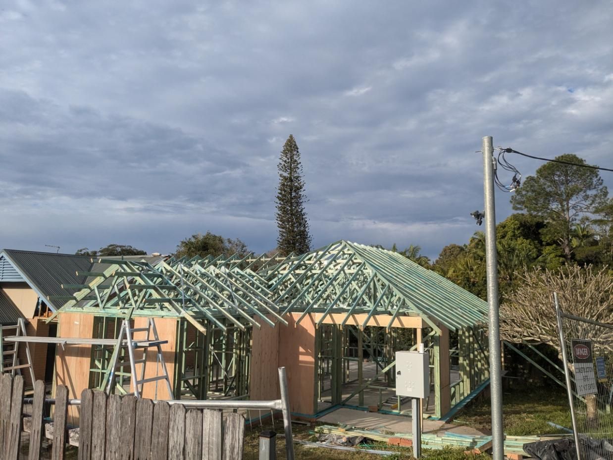 A House is Being Built With a Wooden Roof Frame — BK Build Group in Bellingen, NSW