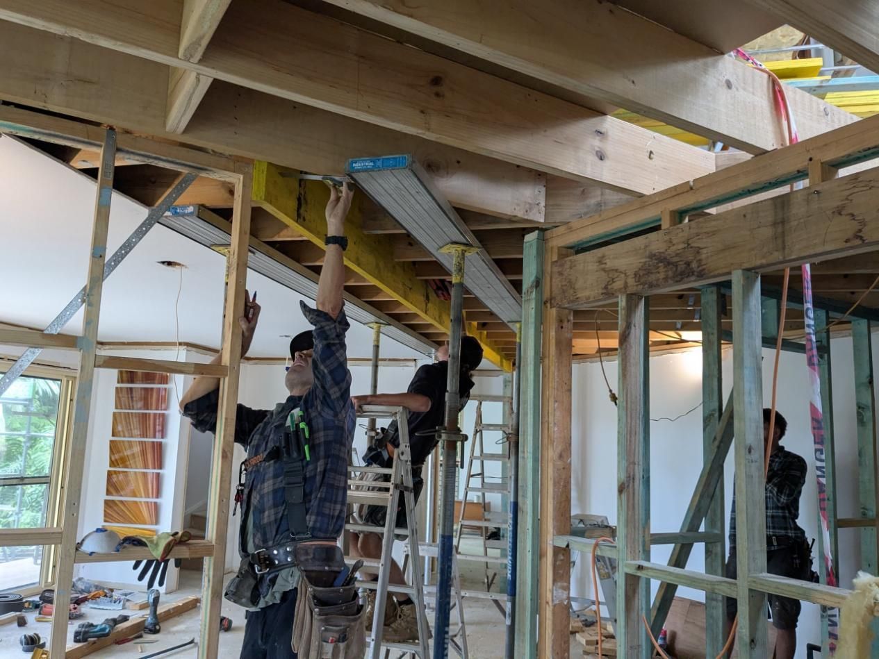 A Group of Construction Workers Are Working on a Wooden Structure — BK Build Group in Woolgoolga, NSW