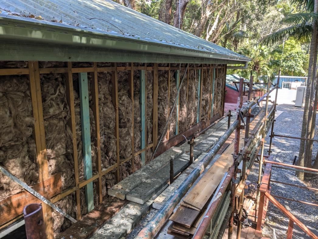 A House is Being Built With Wooden Beams and a Metal Roof — BK Build Group in Woolgoolga, NSW