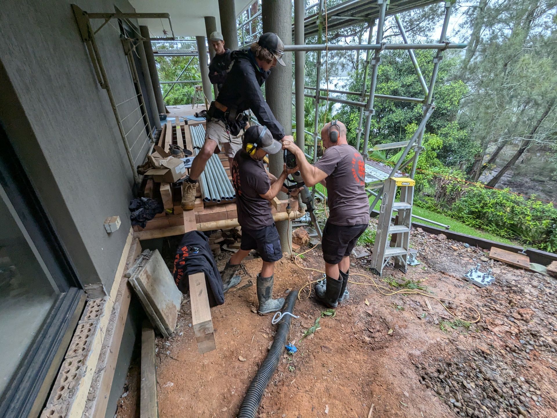 A Group of Men Are Working on a Porch — BK Build Group in Coffs Harbour, NSW