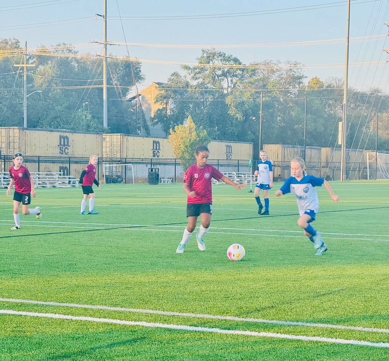 A group of young boys are playing soccer on a field.