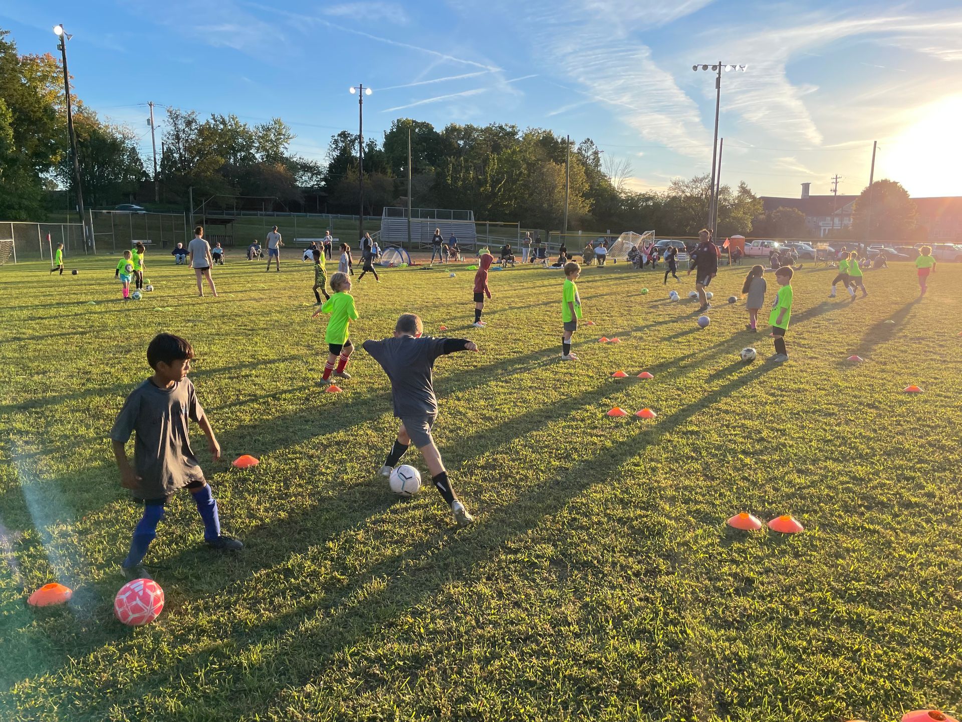 A group of children are playing soccer on a field.