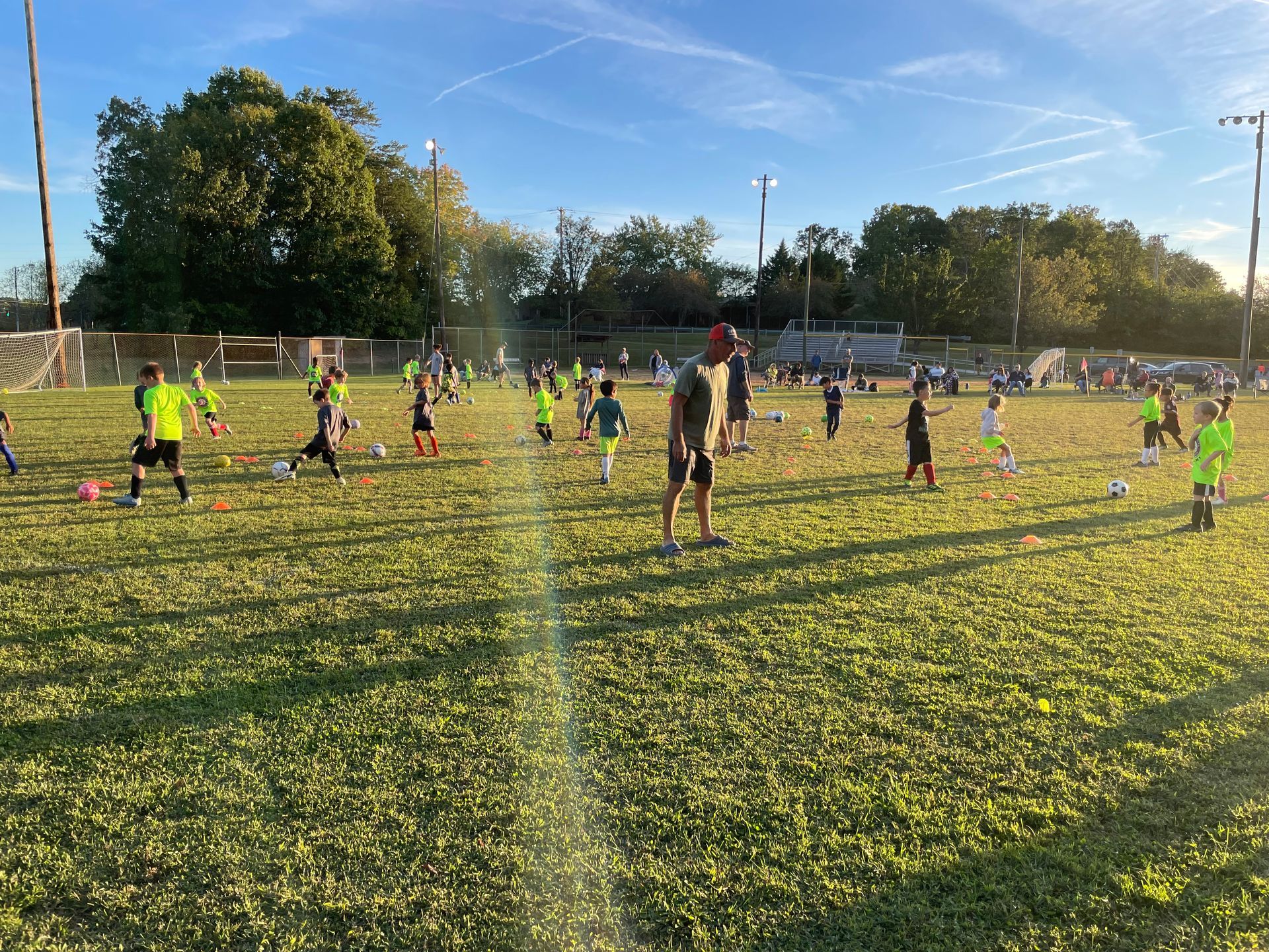 A group of children are playing soccer on a field.