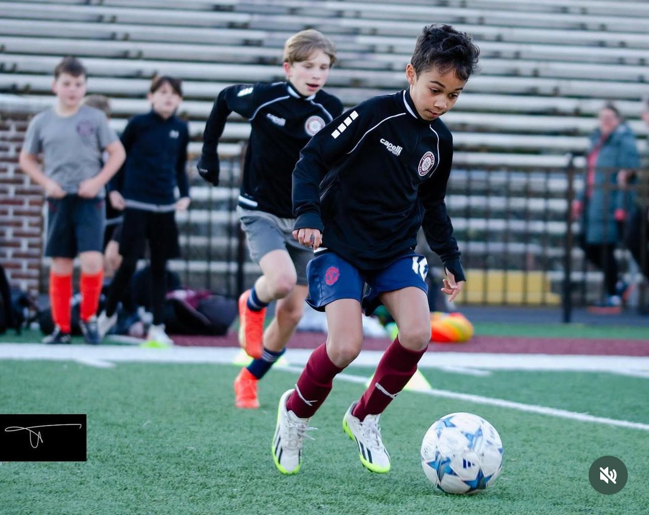A group of young SCOR players are playing soccer on a field.