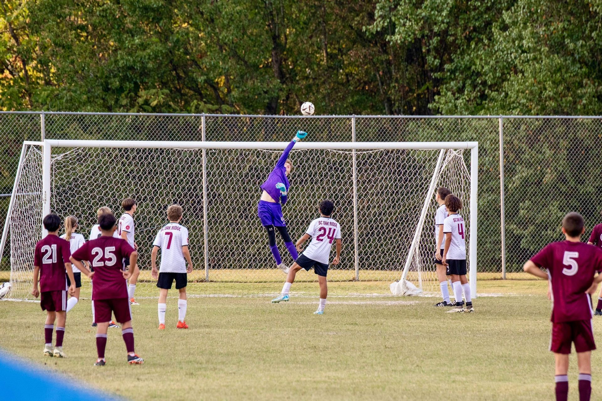 A group of young men are playing soccer on a field.