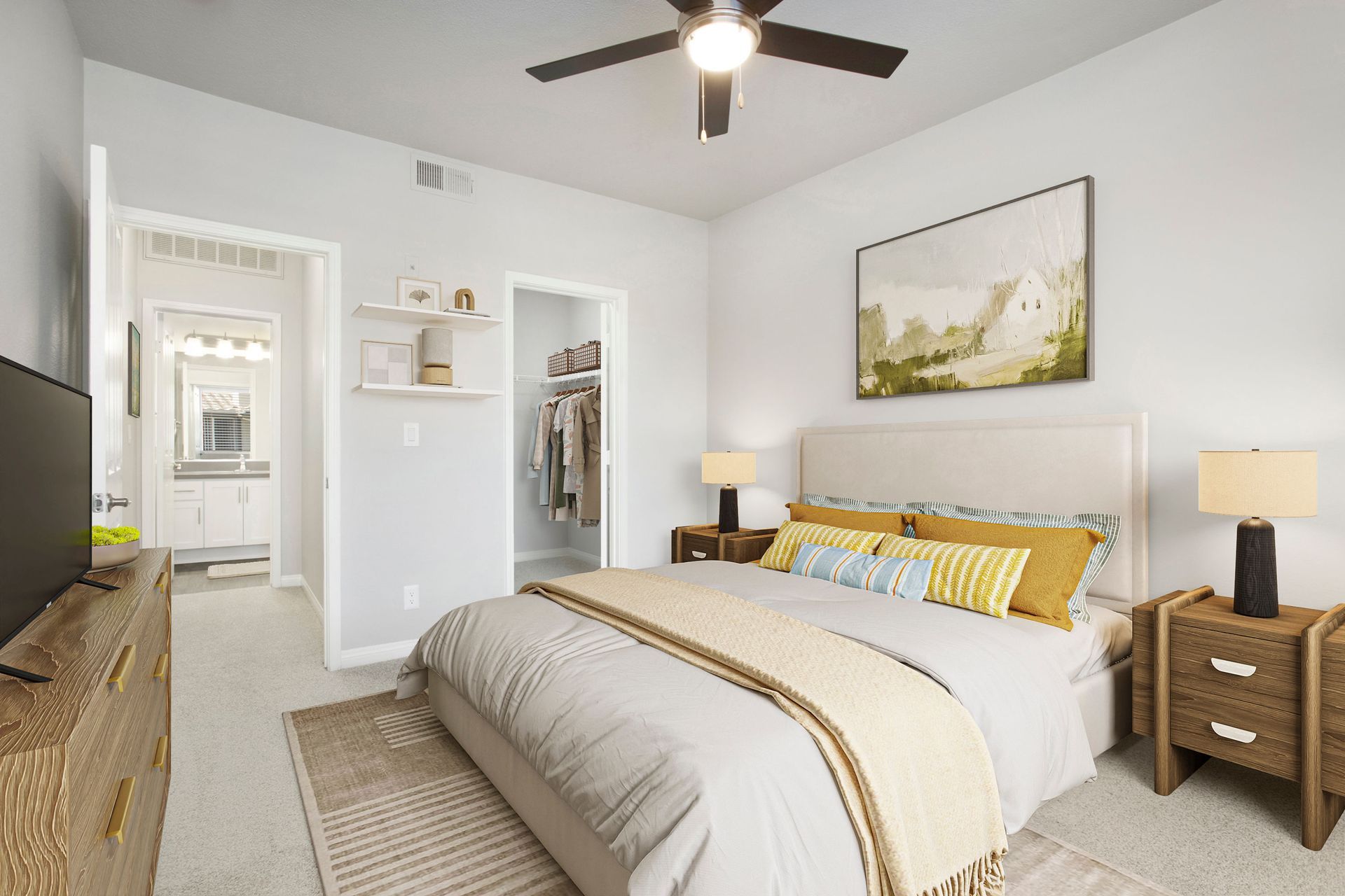 Bedroom with beige upholstered bed, two nightstands, dresser with TV, open closet, and ceiling fan.
