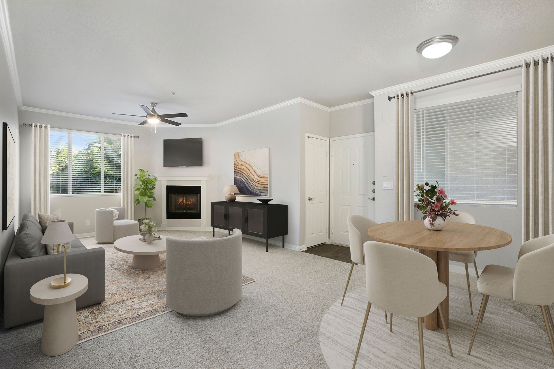 Bright apartment living room with sofa, fireplace, wall TV, and round dining table.