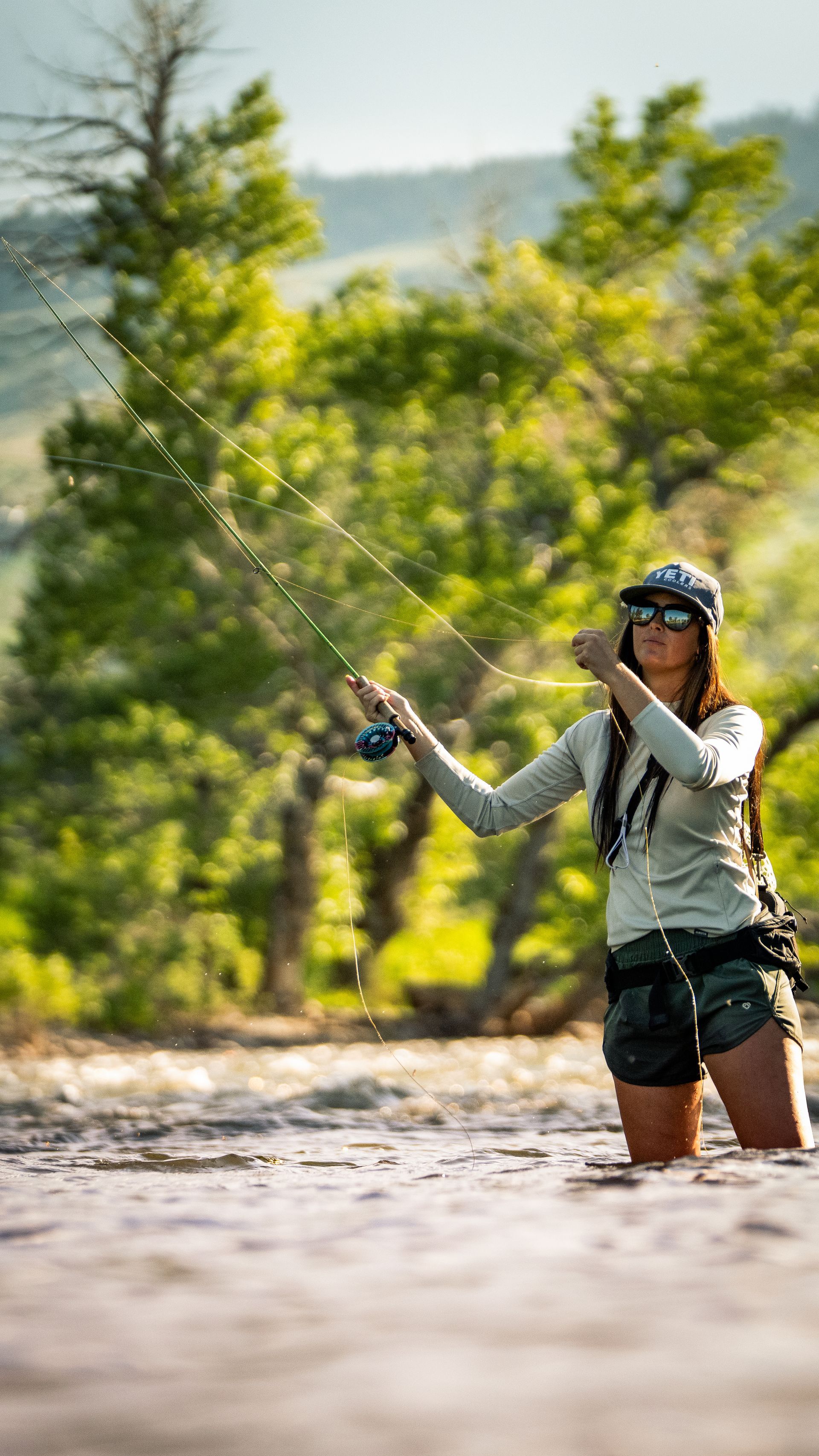 Woman casting a fly rod in the Gallatin river