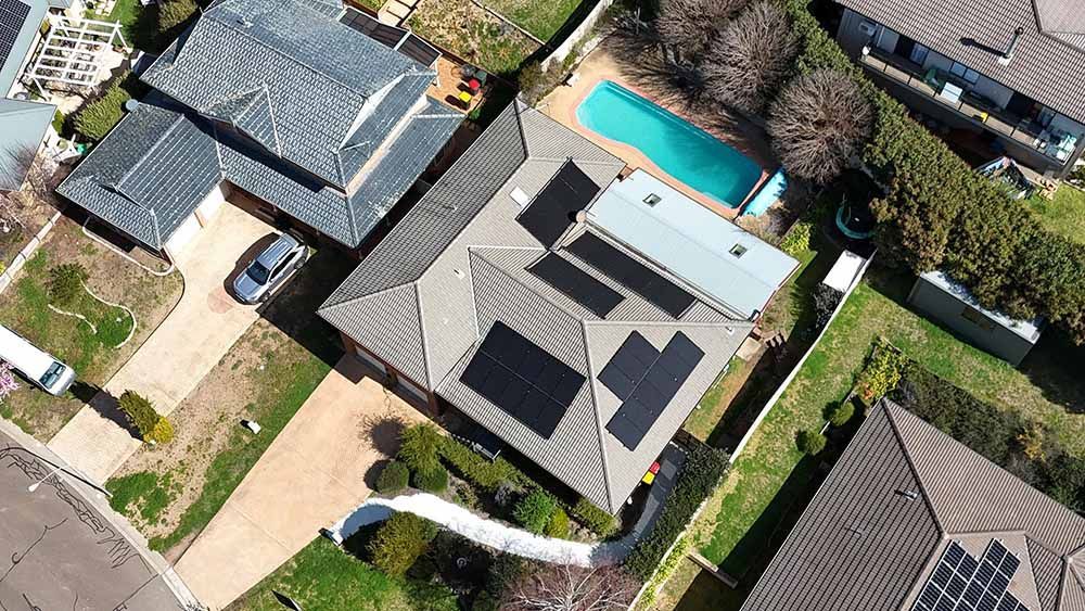 Aerial View Of A House With Solar Panels And Pool — Goulburn Solar In Batemans Bay, NSW