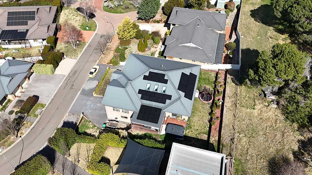 Aerial View Of A Residential Area With Houses And Solar Panels On The Roofs — Goulburn Solar In Merimbula, NSW