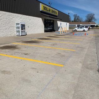 Dollar General store exterior with parking spaces marked by yellow lines.