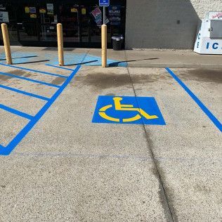 Blue and yellow handicapped parking space in front of a store.