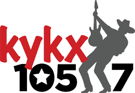 A logo for kykx 105.7 with a cowboy holding a guitar