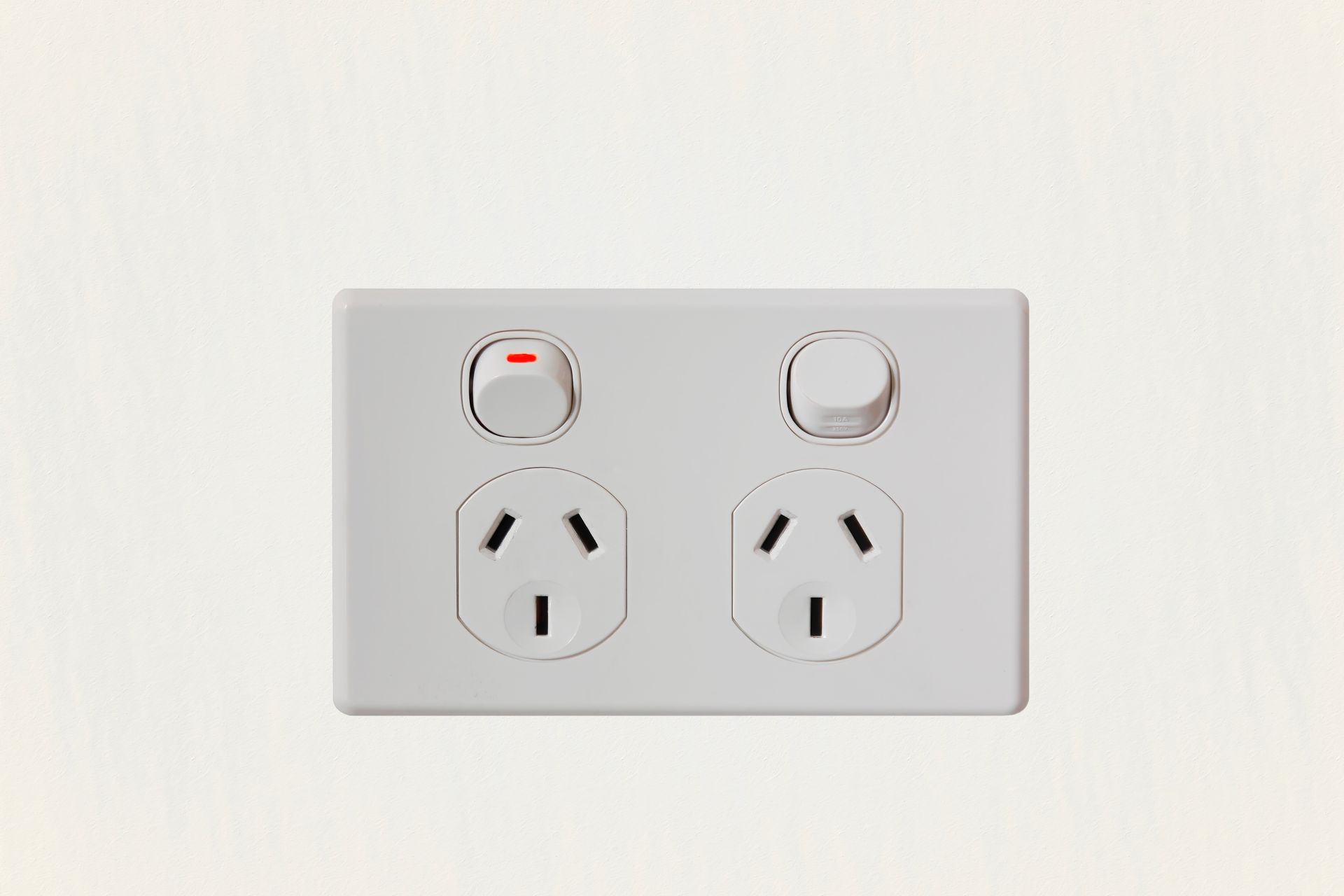 Double power outlet on a gray wall with illuminated strip light below.