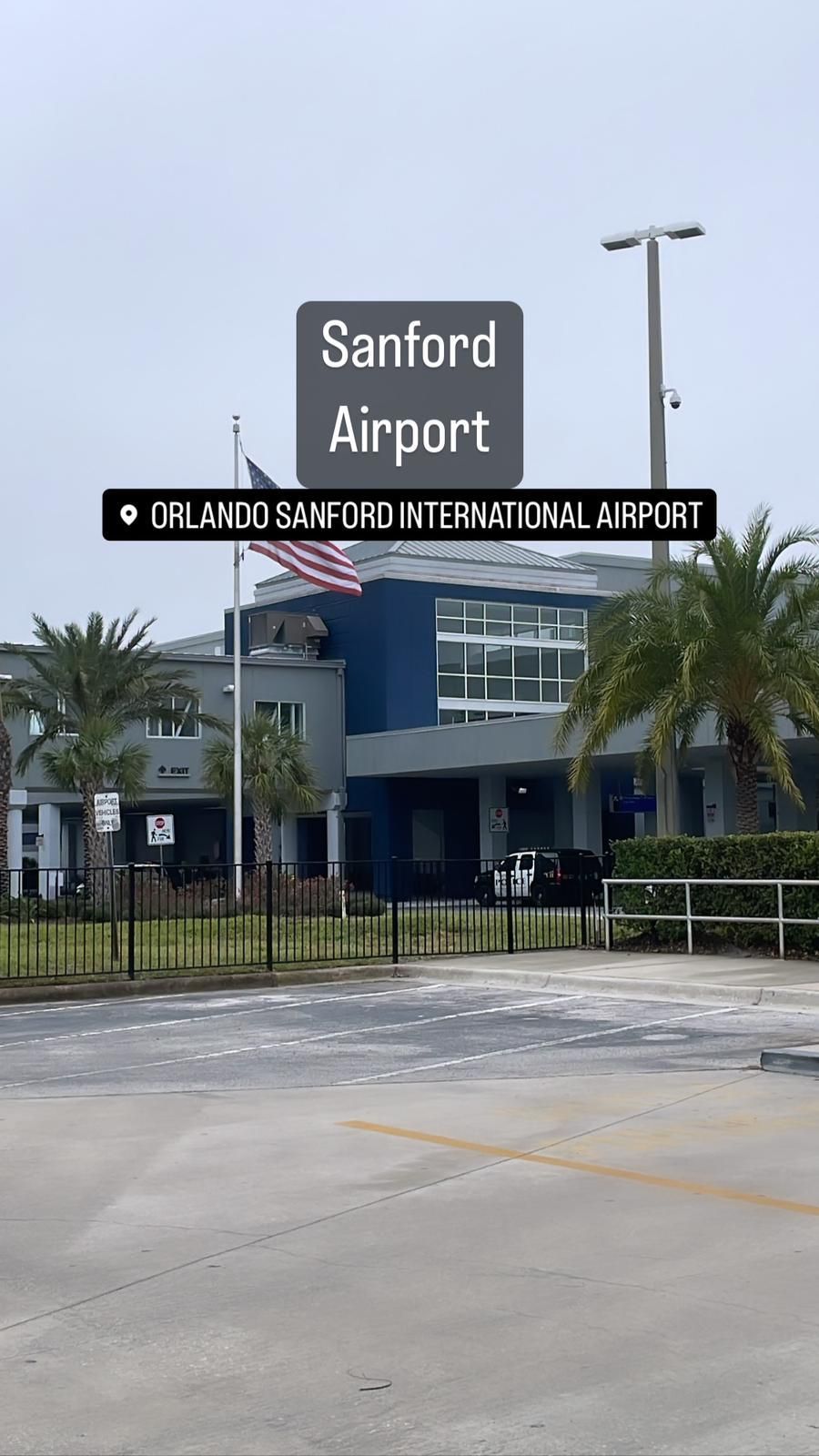 A sign for sanford airport is above a parking lot.