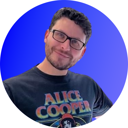 A man wearing glasses and a black alice cooper shirt