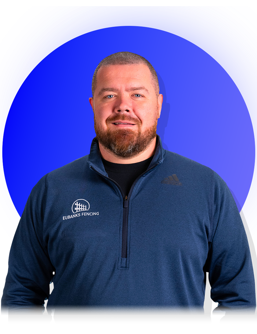 Man with a beard in a blue zip-up, in front of a blue background.