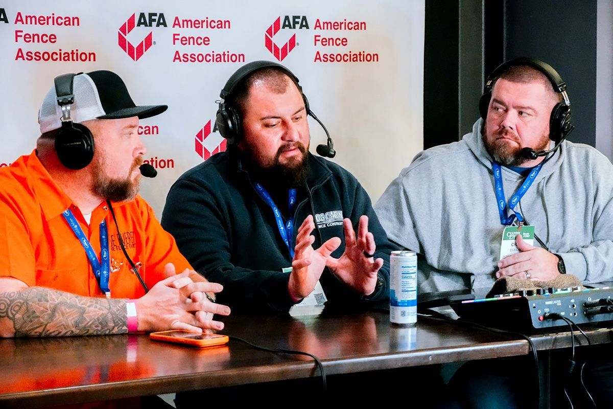 Three men in headsets at a table, likely podcasting, with 