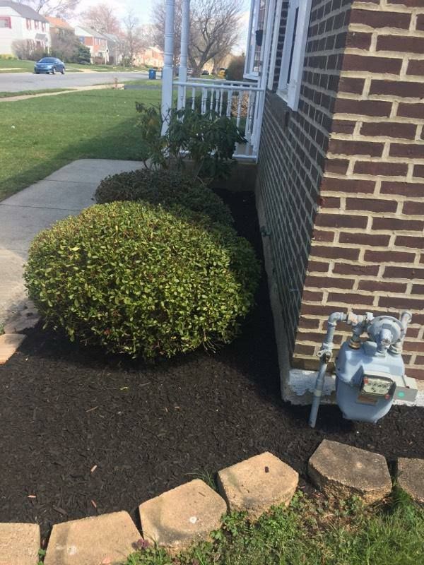 A brick house with a gas meter on the side of it.