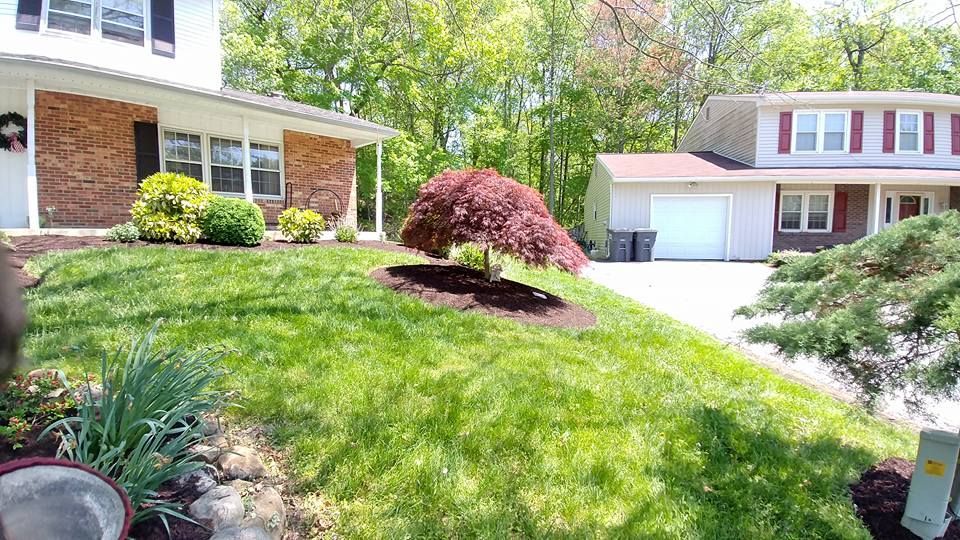 A large house with a lush green lawn in front of it.