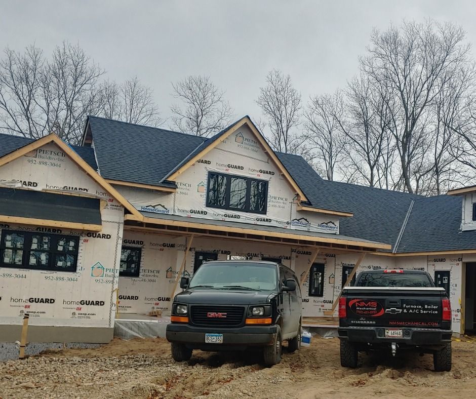 A ladder is sitting on the side of a building next to a wall.
