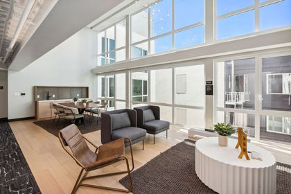 A living room with a lot of windows and furniture.