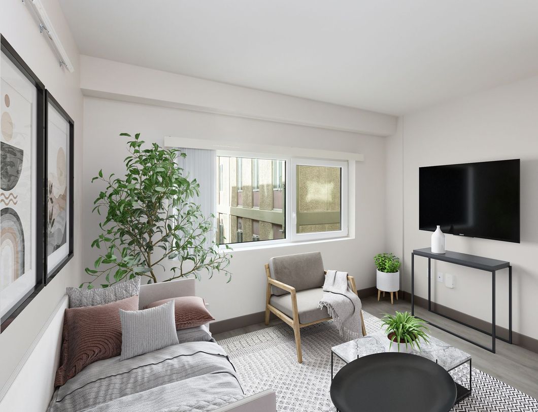 A living room with a couch , chair , table and television.