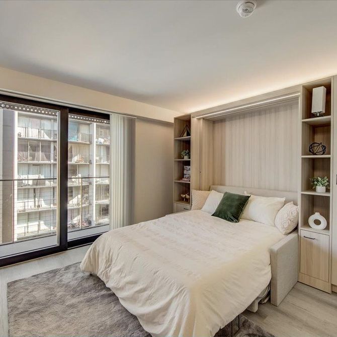 A bedroom with a bed and sliding glass doors