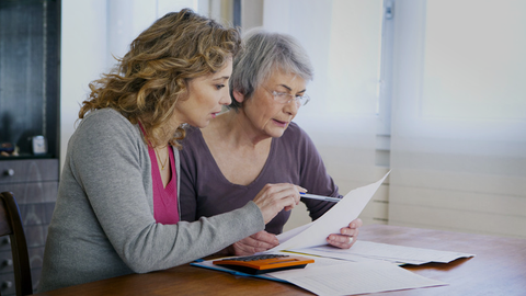 an elderly lady consulting a Will adviser